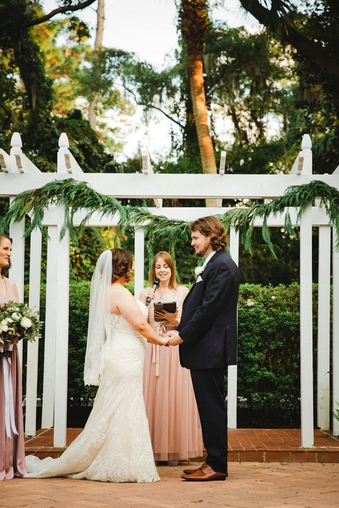wedding under arch with moss hanging