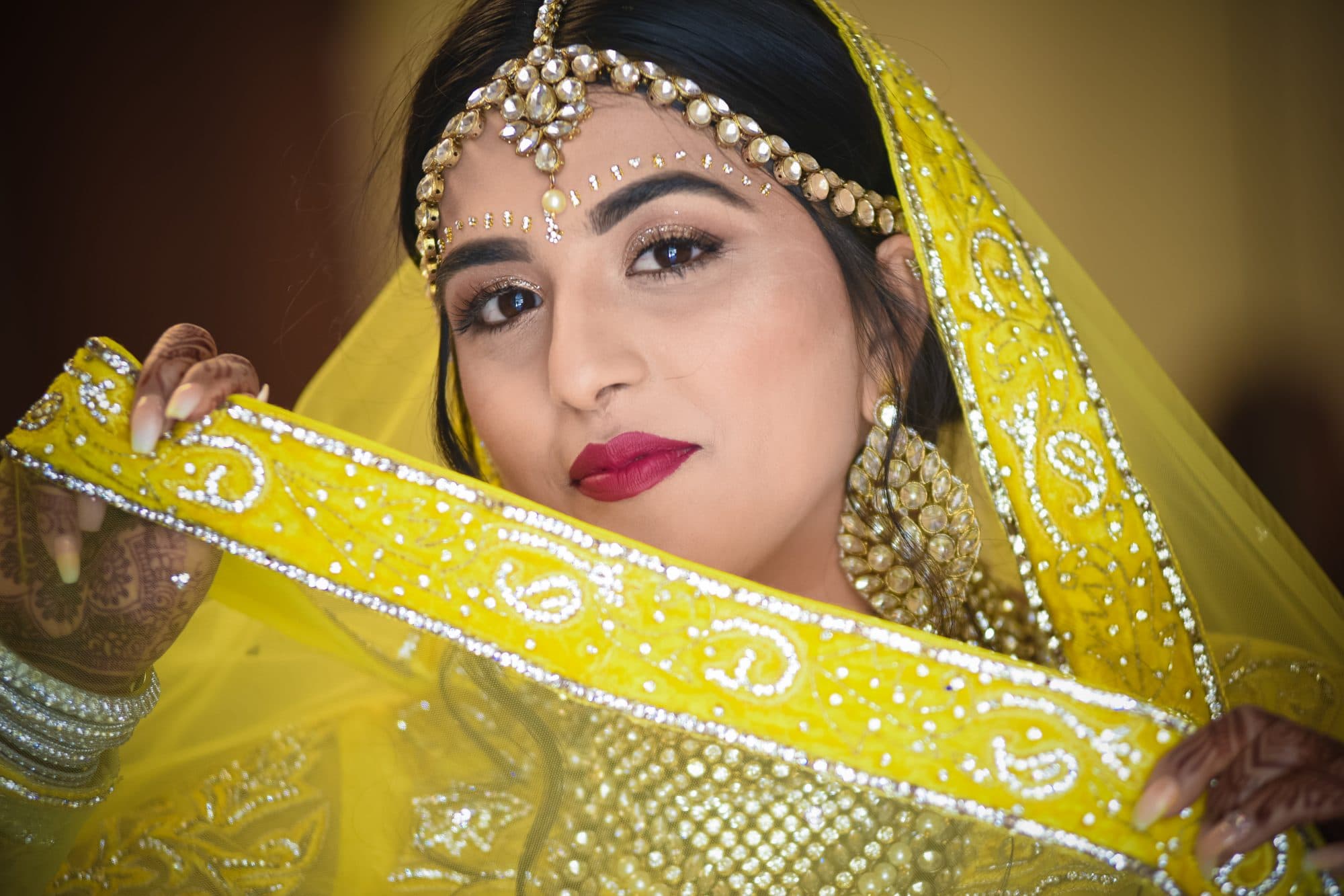 Chris Gillyard Photography - beautiful Indian bride showing off beading on yellow sari