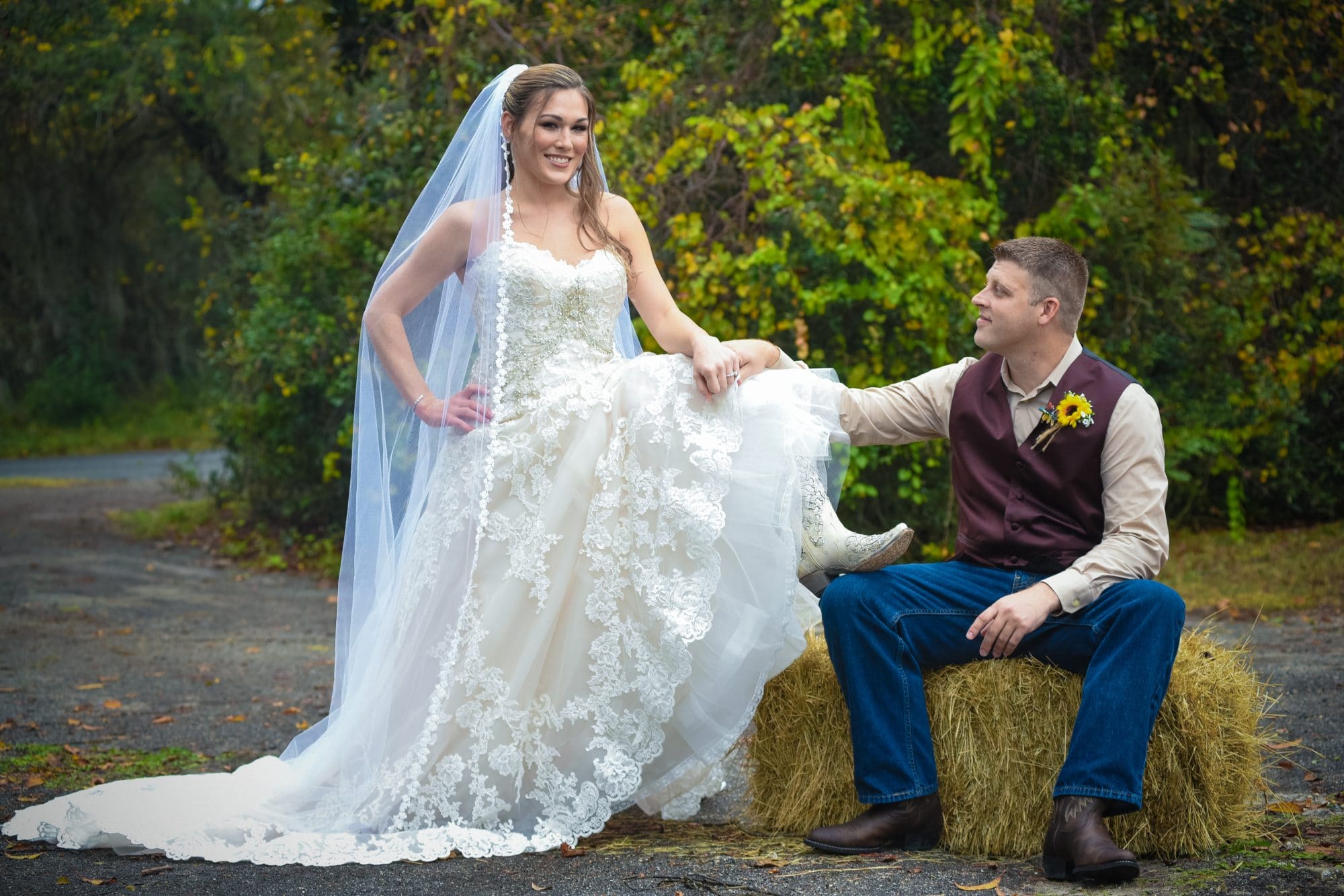 Chris Gillyard Photography - country newlyweds posing on bale of hay