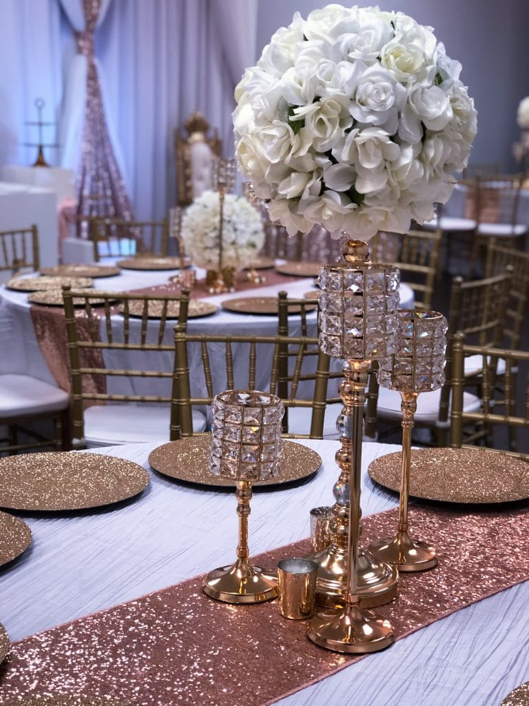 Destiny Event Venue - reception centerpieces with white roses and gold candleholders