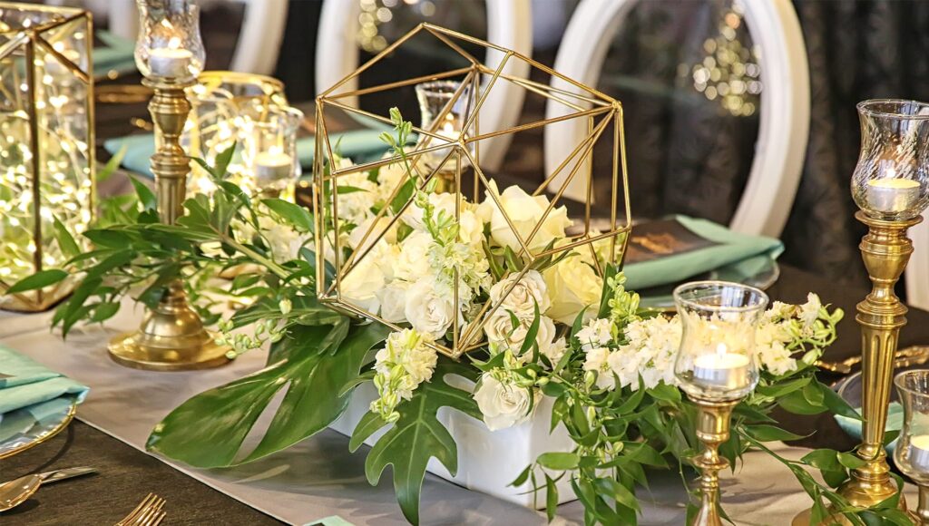 small white and green floral arrangement in gold geometric container by Fairbanks Florist