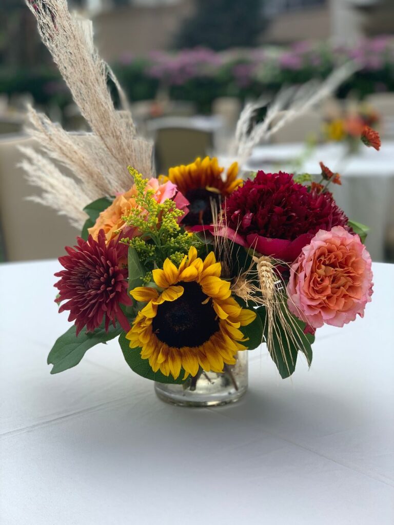 small floral arrangement with sunflower, pink flowers, and fall grass