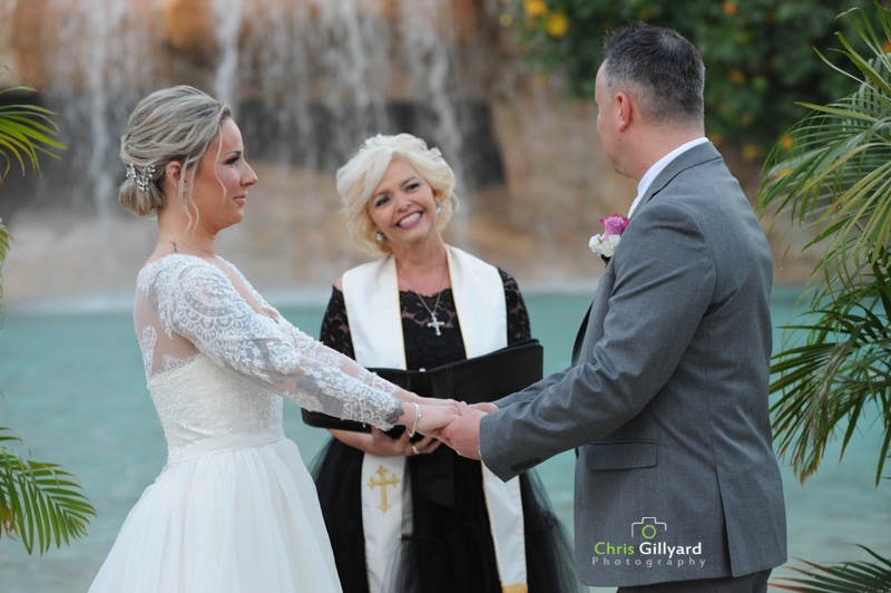 bride and groom and officiant in front of rocks and waterfalls - chris gillyard orlando wedding photography