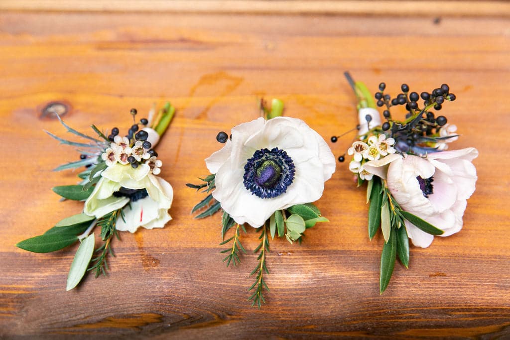 boutonniere with white and blue flowers from The Flower Studio