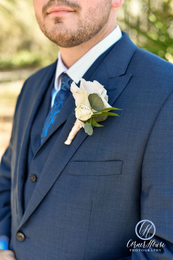 boutonniere pinned to groom's lapel