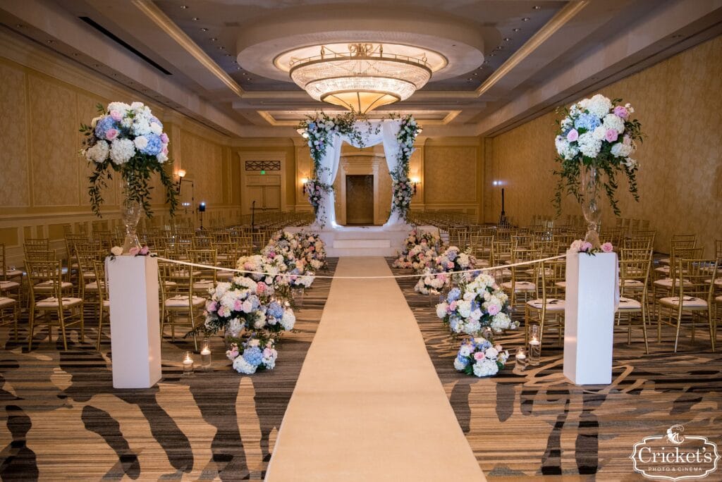 room set up for wedding reception with raised platform in middle of the room for the ceremony