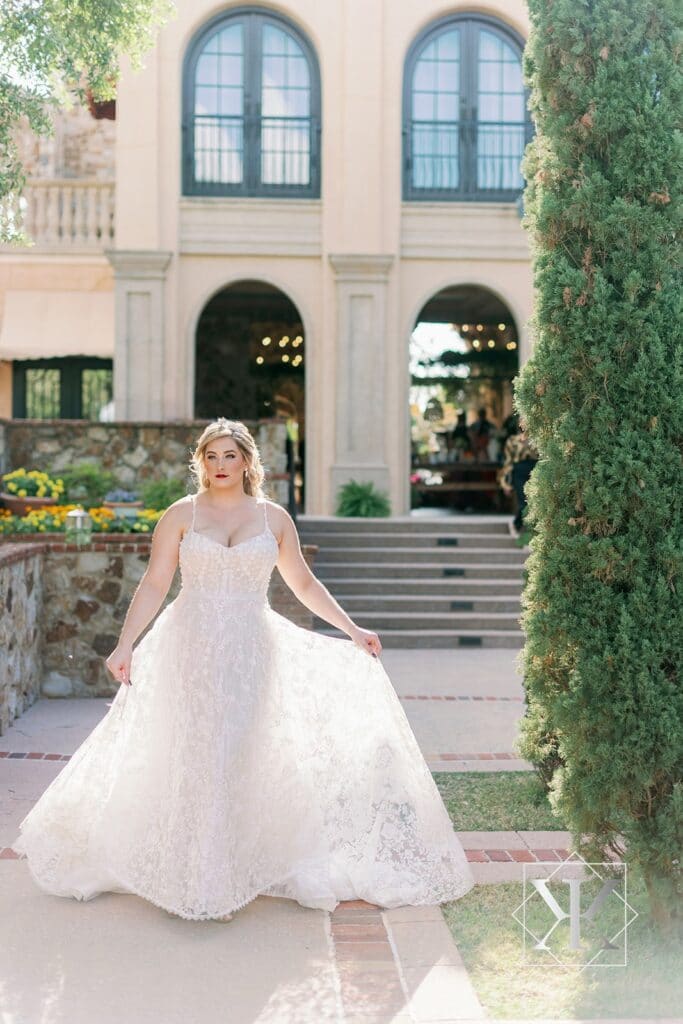 bride in dress from Solutions Bridal walking in courtyard