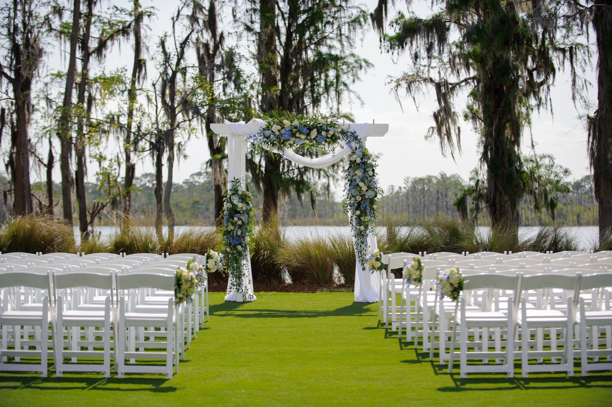 Floral decorated trellis at outdoor wedding ceremony