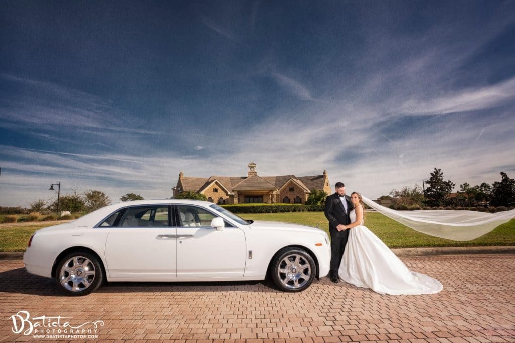 Exotic-Limo-Orlando-Brdie & Groom standing next to white rolls royce ghost