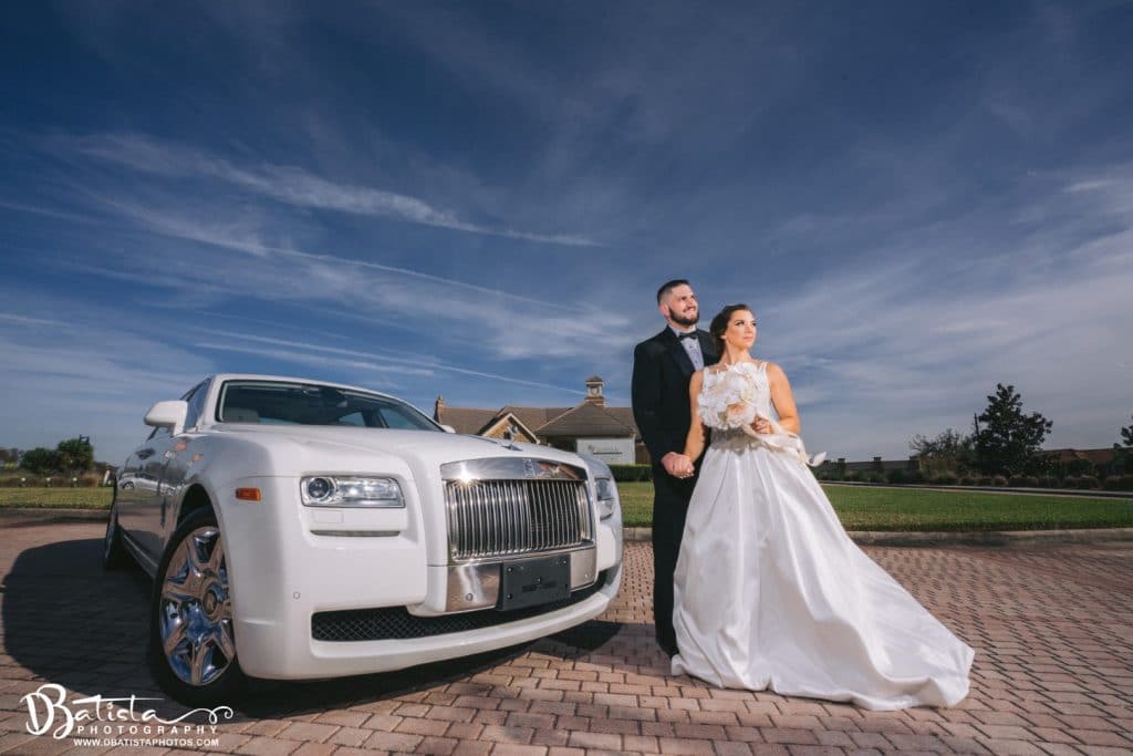 Exotic-Limo-Orlando-Couple standing at the front of beautiful RR Ghost