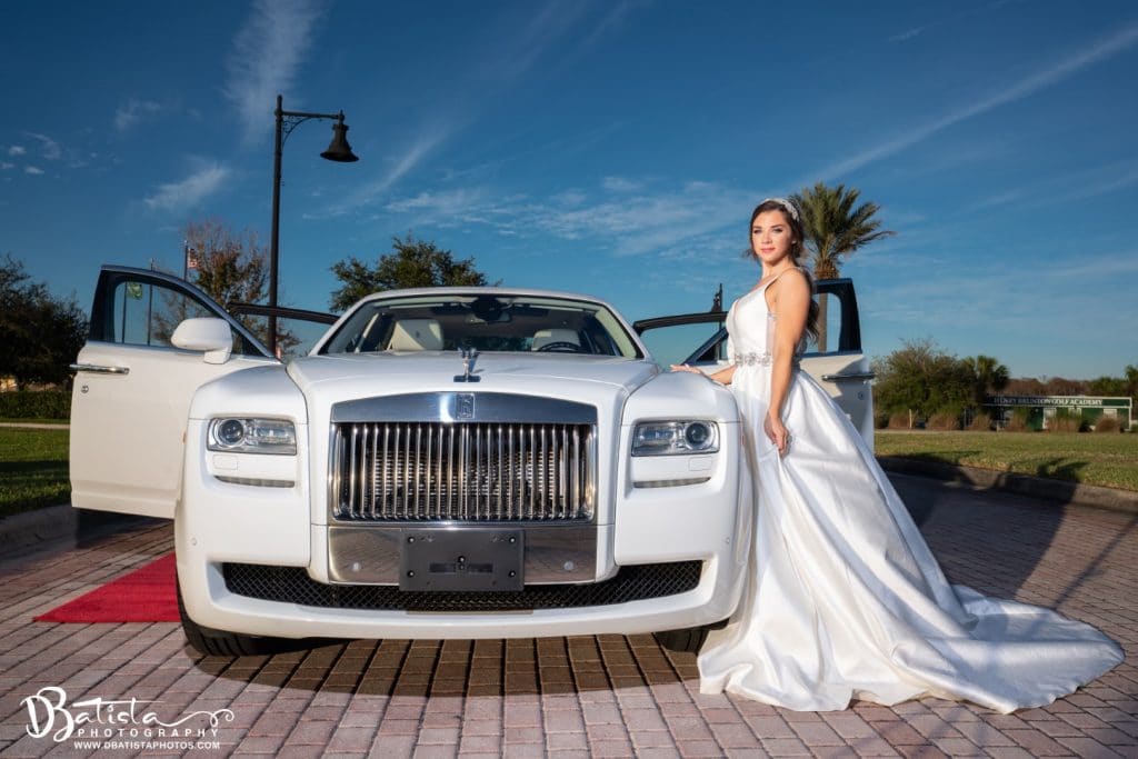 Exotic-Limo-Orlando-Front of White Rolls Royce Car with Bride standing next to it