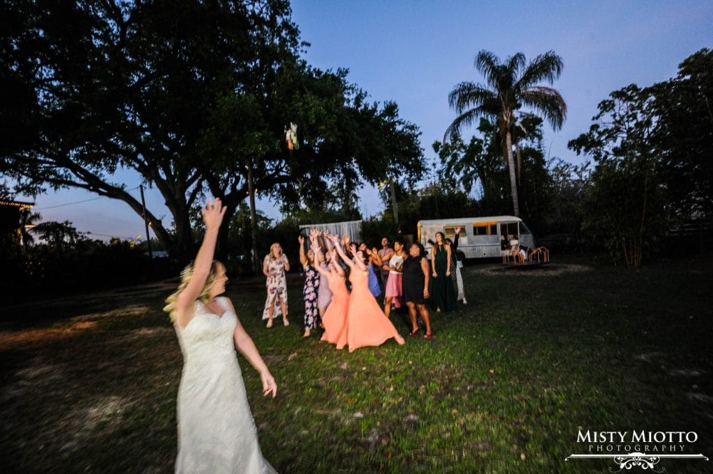 Live-Love-Laugh-Events-Bride tossing her bouquet to wedding guests at night