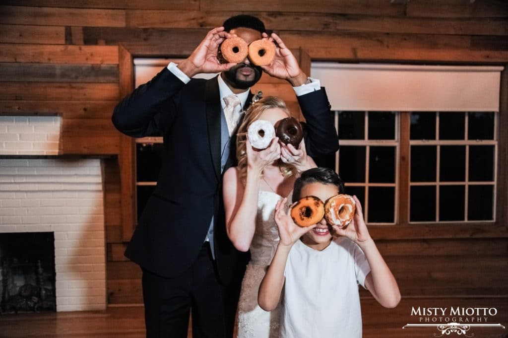 Live-Love-Laugh-Events-Bride, Groom and child holding donuts over their eyes