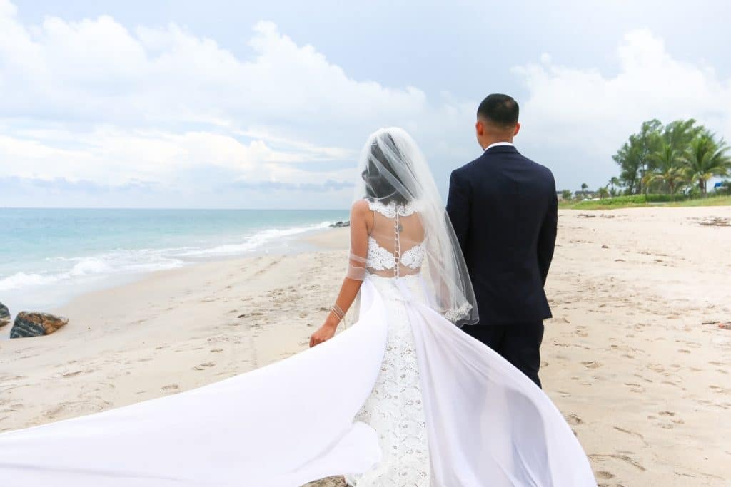 Live-Love-Laugh-Events-Bride and Groom walking on the beach holding hands