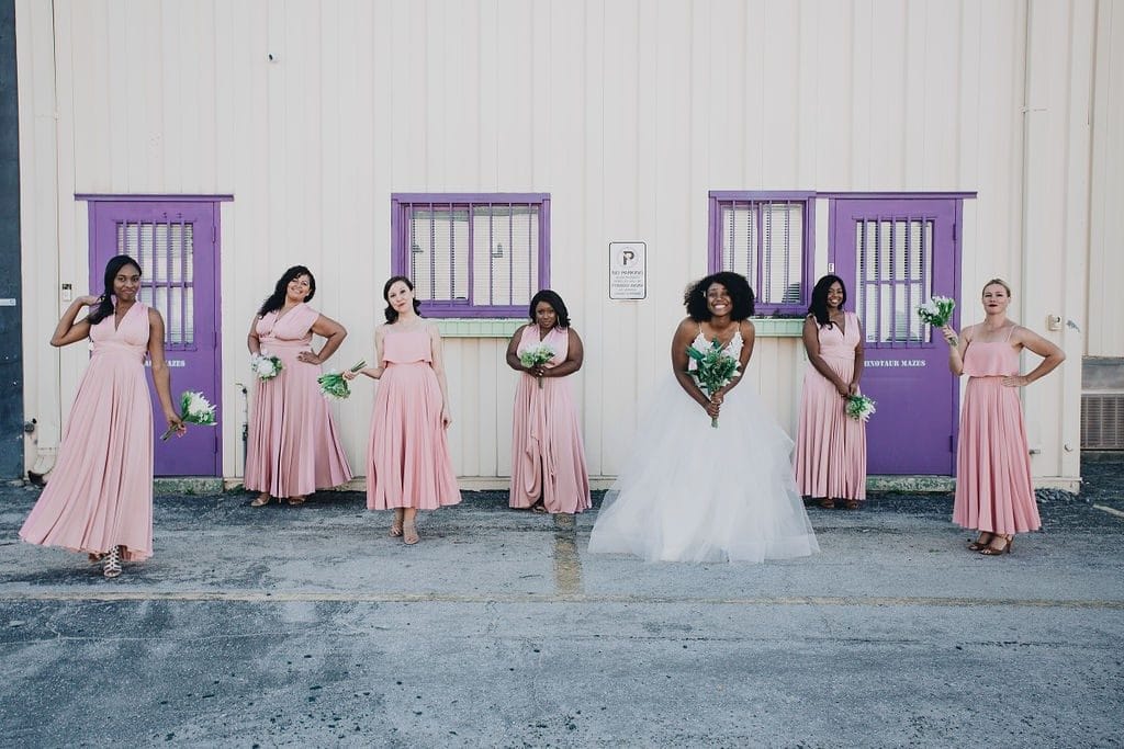 Live-Love-Laugh-Events-Bridal party and Bride standing in front of white building with purple doors