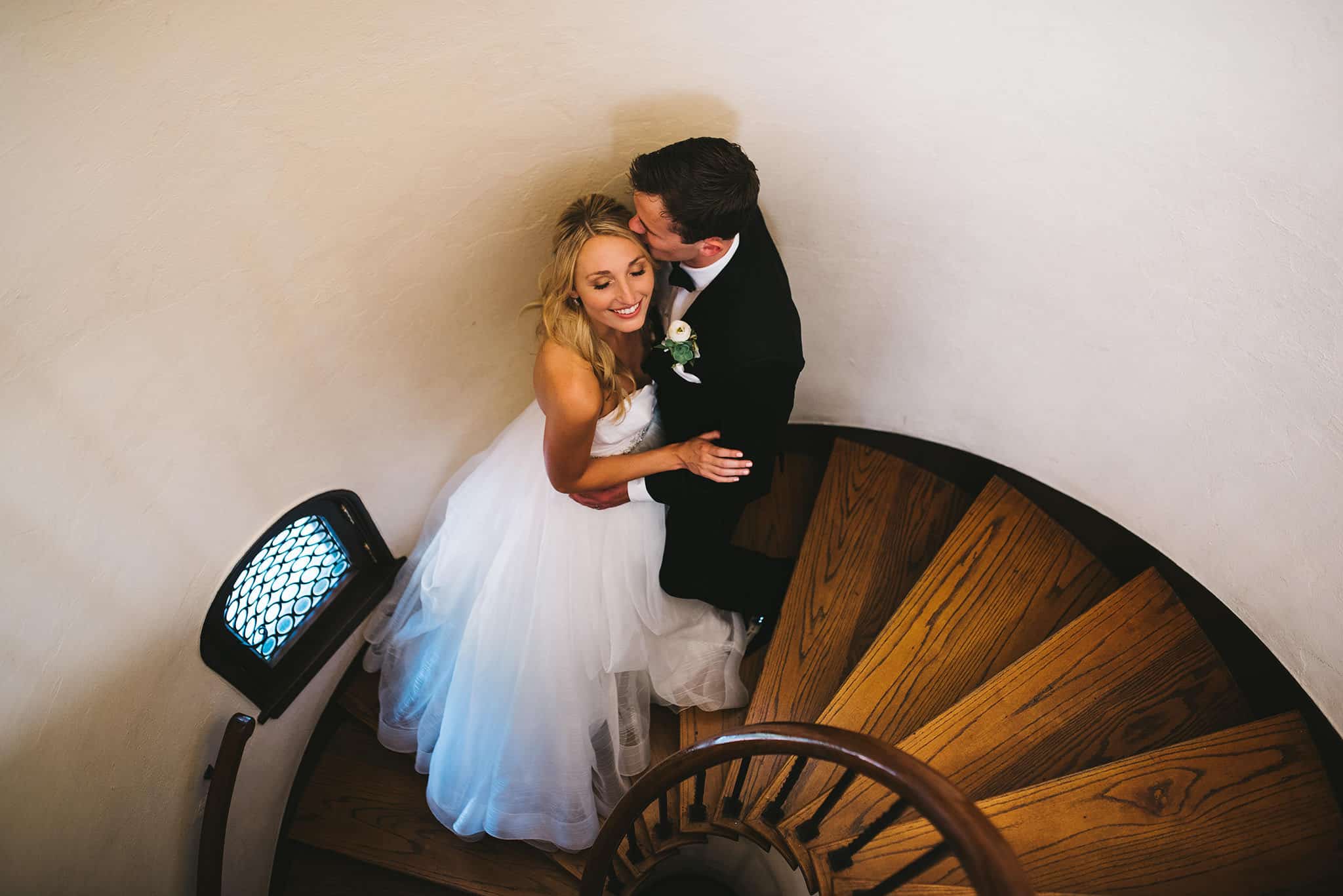 Rudy & Marta Photography - aerial shot of bride and groom on spiral staircase