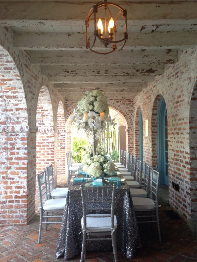 Connie-Duglin-Linen-Silver sequin linen, silver chairs, tiffany blue napkin accetns and large white floral centerpiece