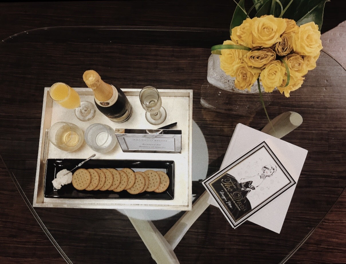 Solutions Bridal - coffee table with tray of cheese, crackers, and mimosas