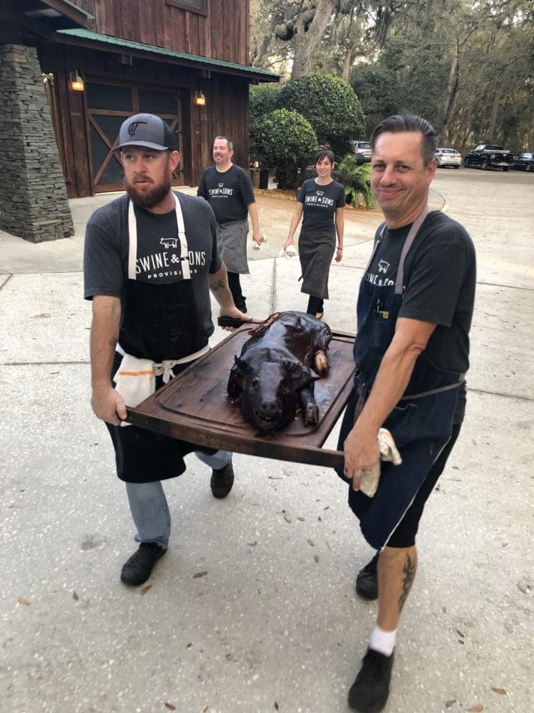 Swine & Sons - whole smoked pig being brought into wedding reception