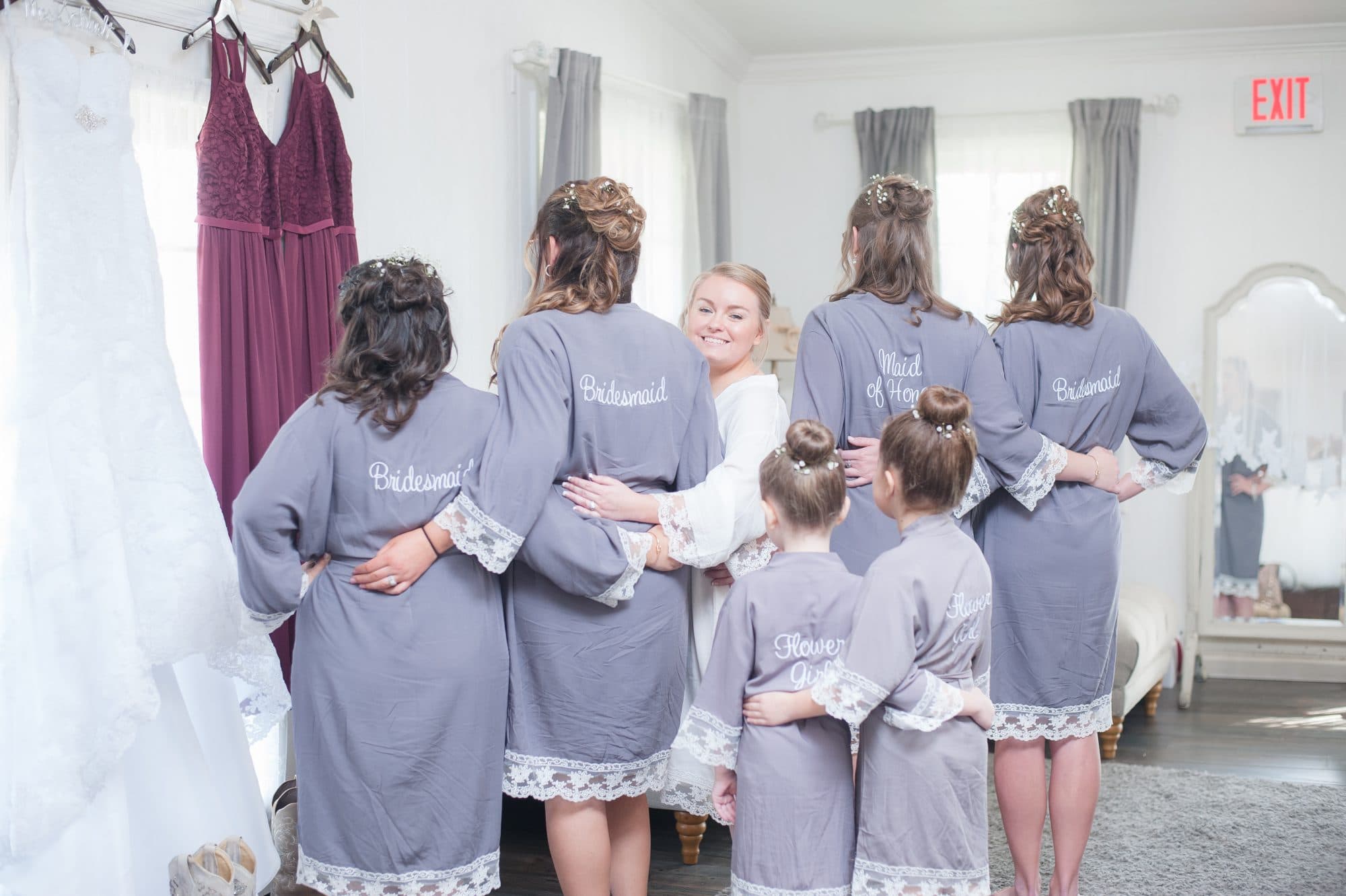 Bride, bridesmaids, and flower girls in matching robes.