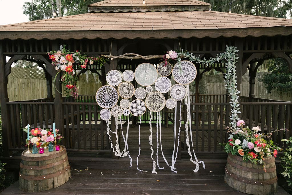 Harmony Haven Events - rustic outdoor ceremony space with woven decorations and rustic wooden backdrop