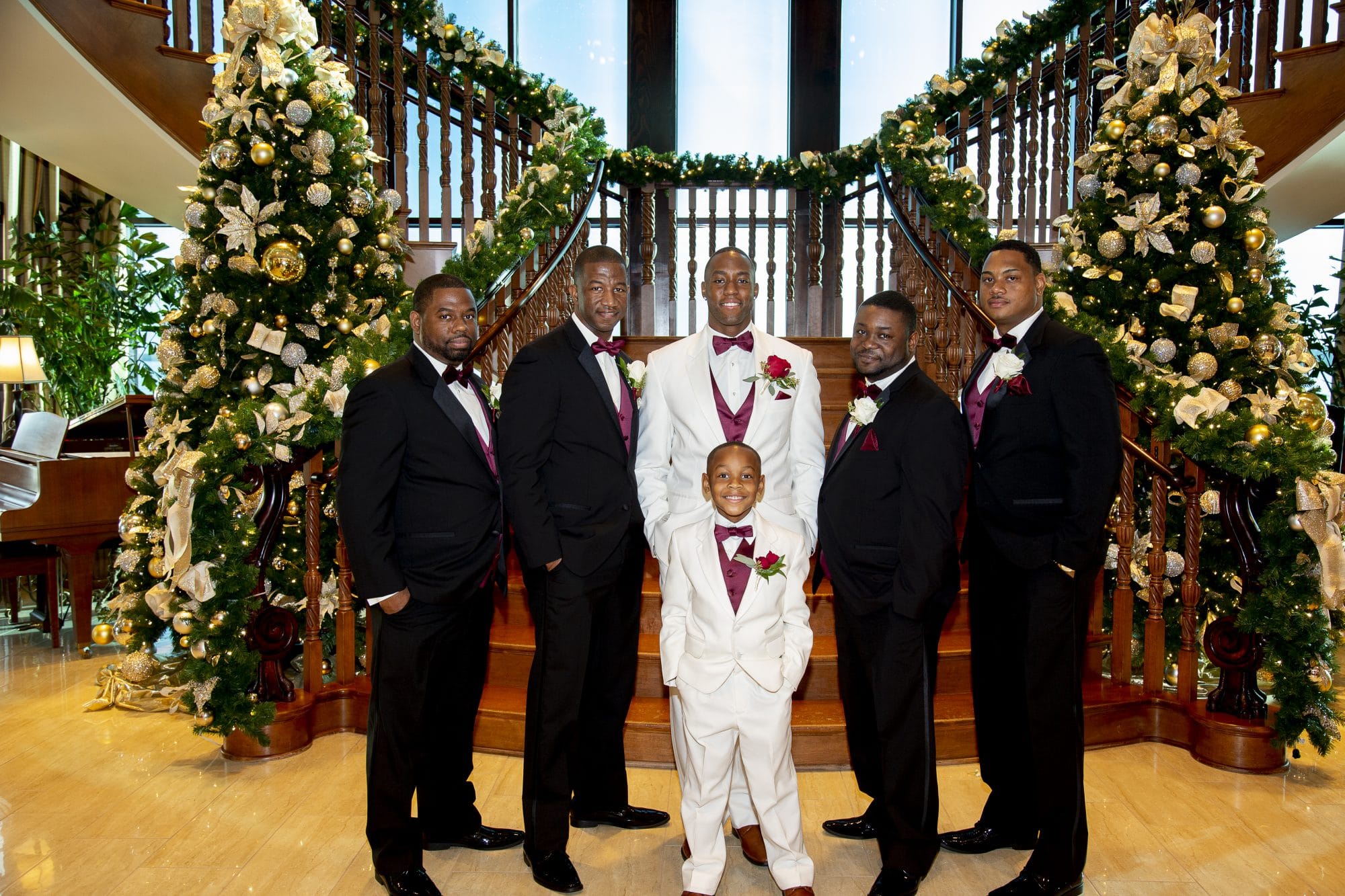 Richard, groomsmen, and ring bearer in front of staircase