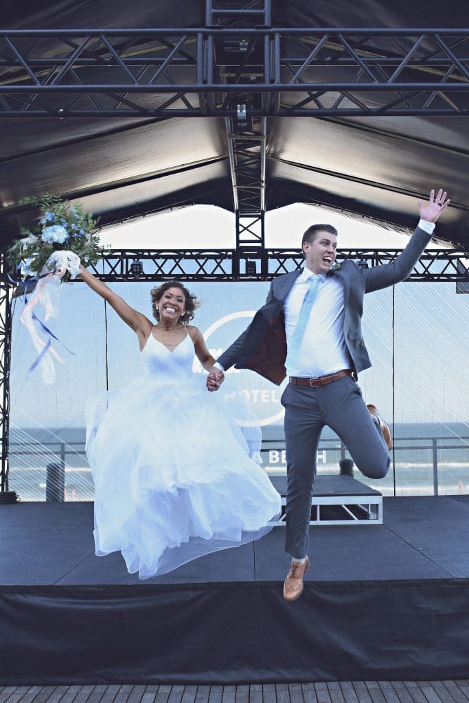 bride and groom leaping off stage