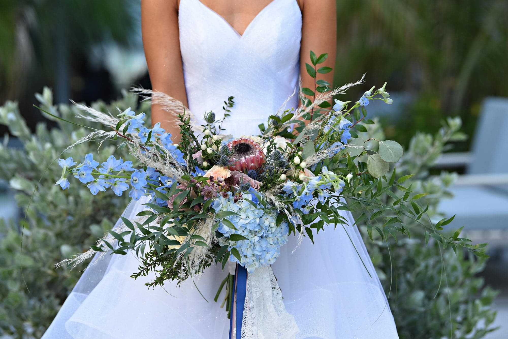 bride holding loose, sprawling bouquet