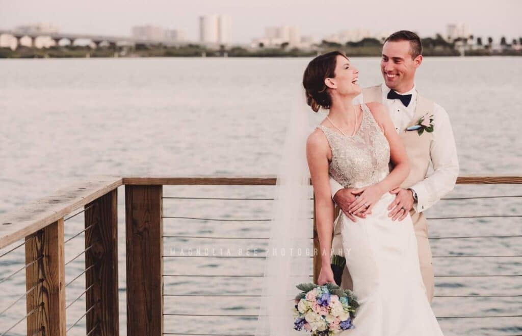 riverside-pavilion-Bride and groom laughing on dock