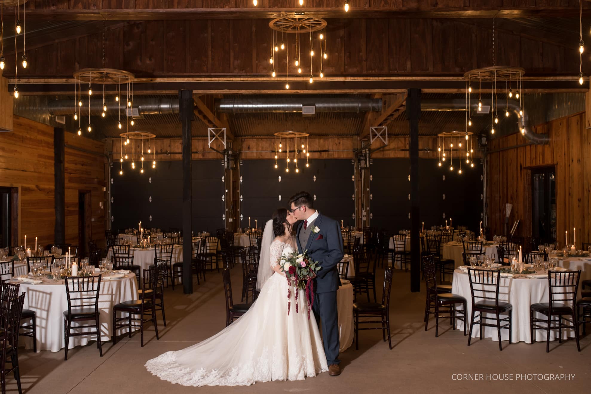 bride and groom kissing in the entrance to club lake barn wedding venue