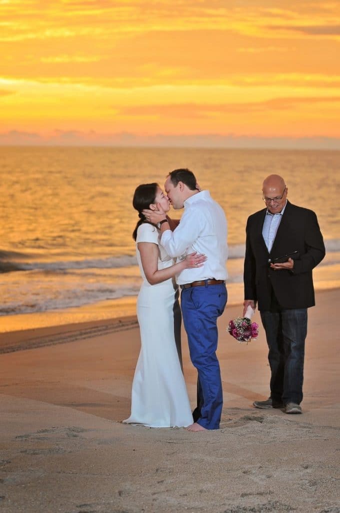 Pastor-Mike-Weddings-Bride and Groom kissing at sunset on beach.