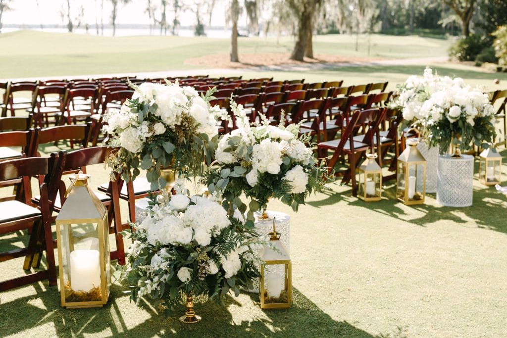 outdoor wedding reception aisle entrance with candles and flowers