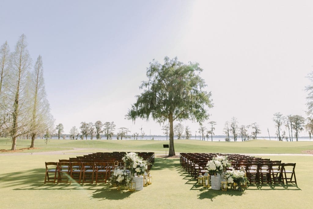 outdoor wedding ceremony with aisle ending at lone tree n the middle of a field by Runway Event