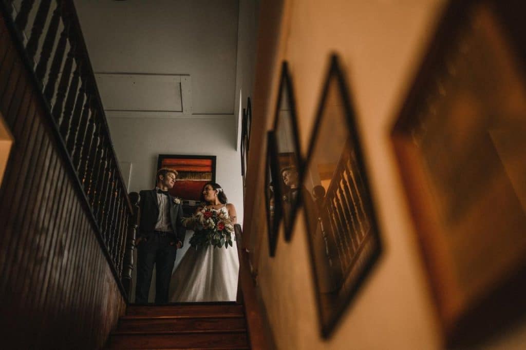 The-Event-Company-Bride standing at top of stairs with man in tux