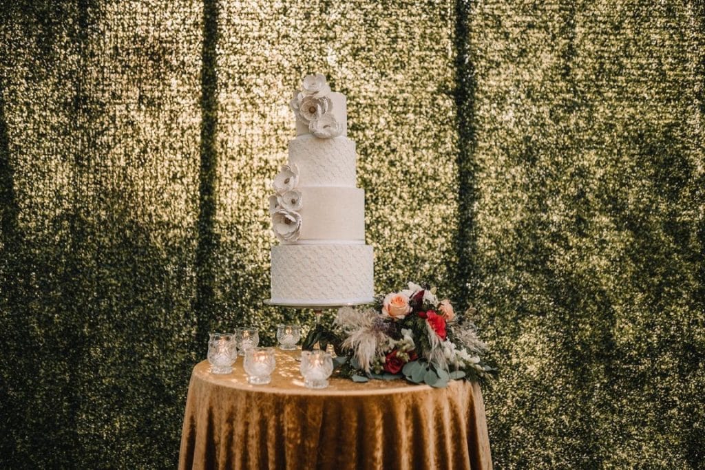 The-Event-Company-4 tier white wedding cake on gold sequin table cloth