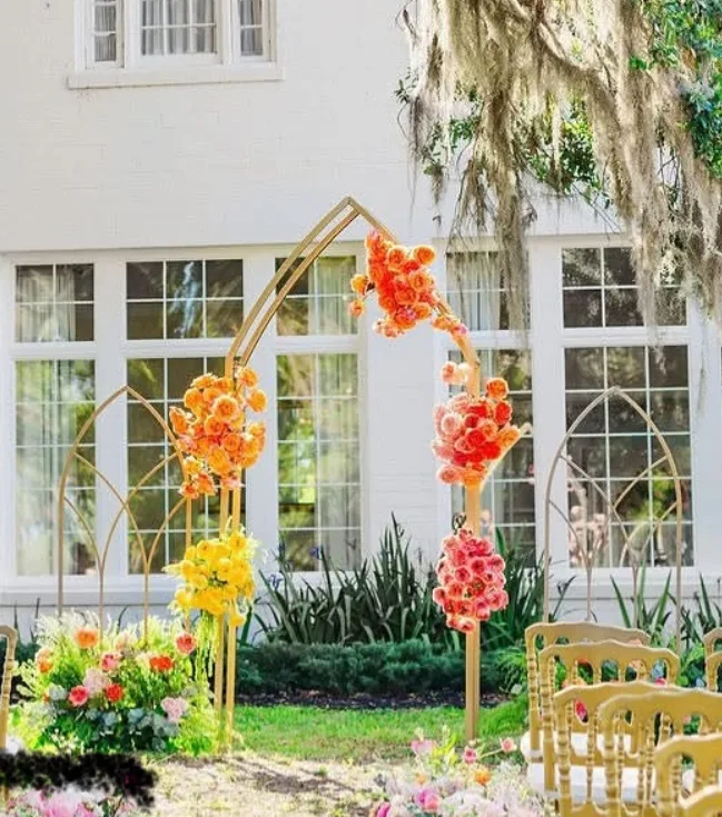 gold wedding arch with red and yellow floral