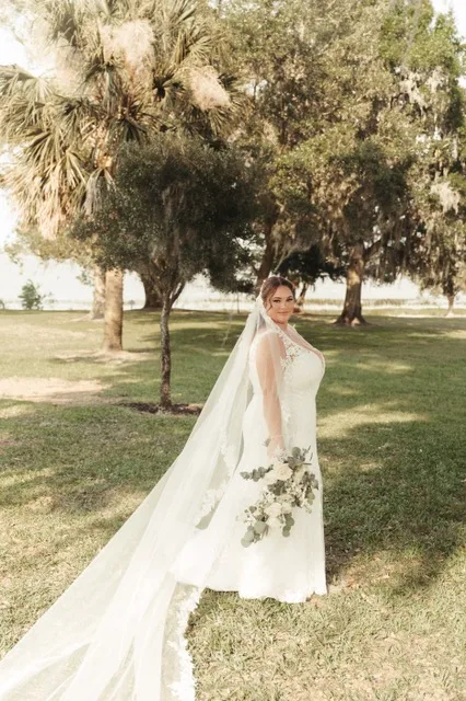 florida bride holding bouquet of white roses and eucalyptus leaves