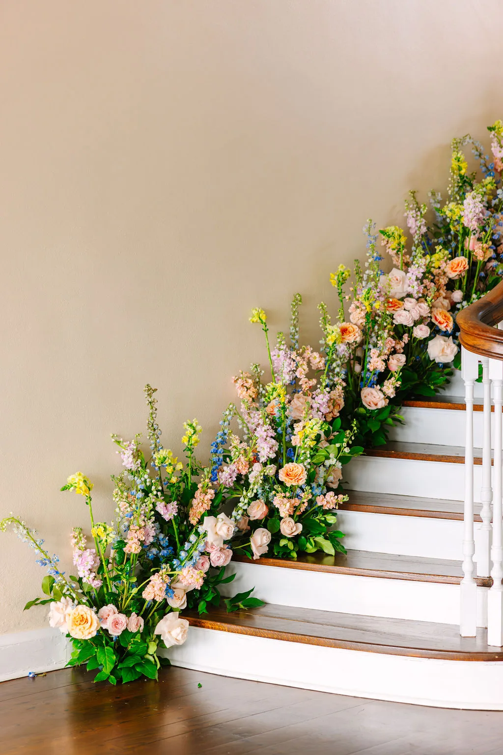 spring floral arrangements along wooden staircase by jill heaton floral design