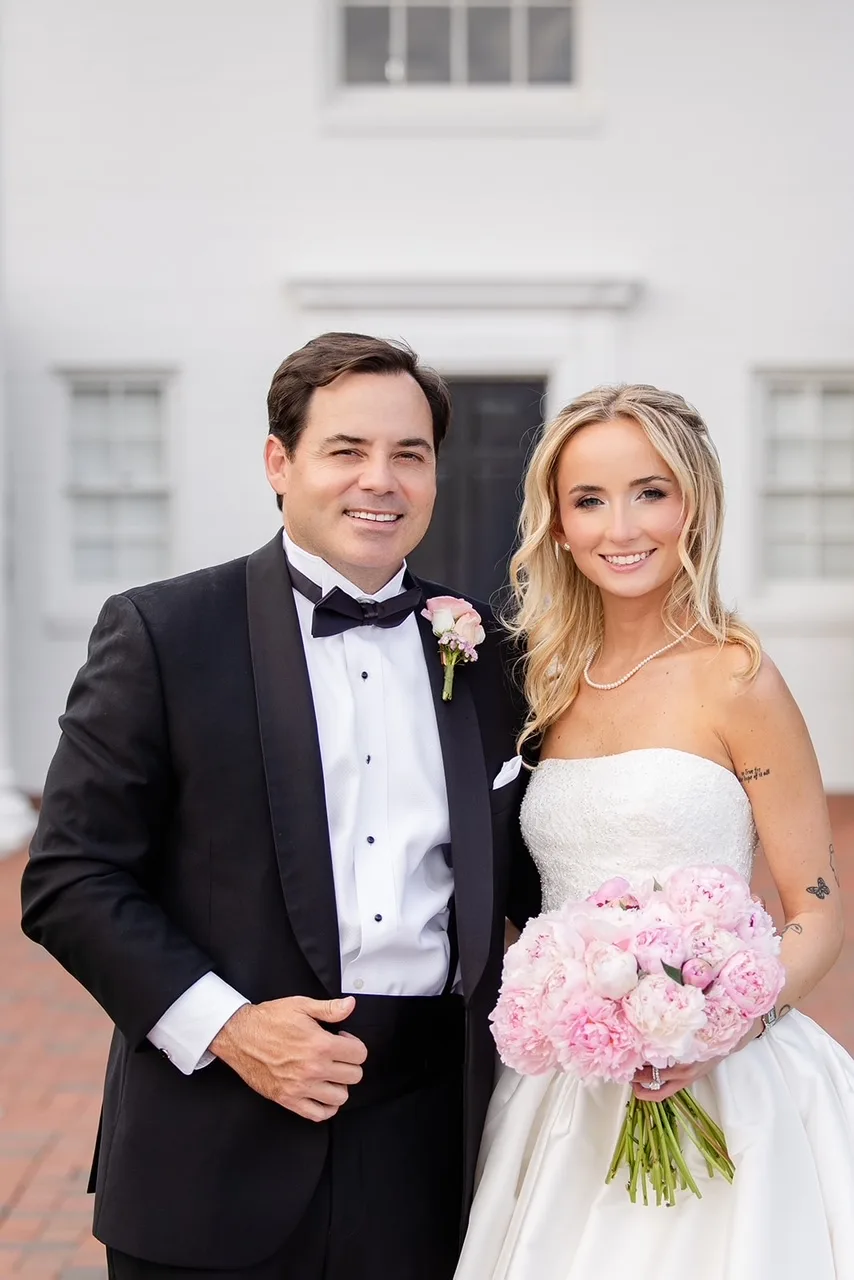 bride holding light pink bouquet and groom with pink boutonierre from jill heaton floral design in florida