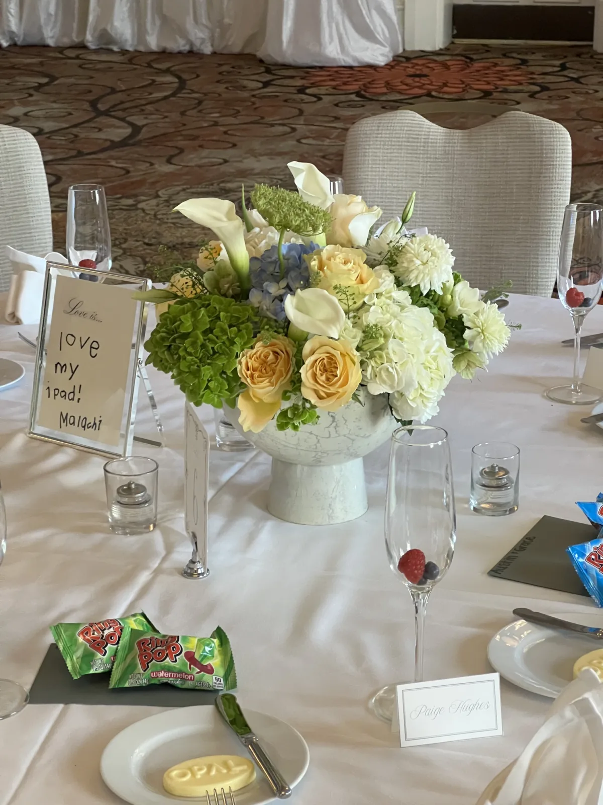 white, yellow, and green floral arrangement for wedding table centerpiece