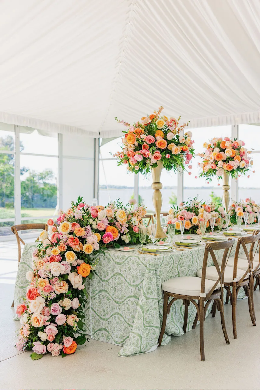jill heaton floral design d245d29a - Jill Heaton Floral Design modern wedding tablescape with tall centerpieces and lush floral garland of white, pink, and orange roses under white wedding tent