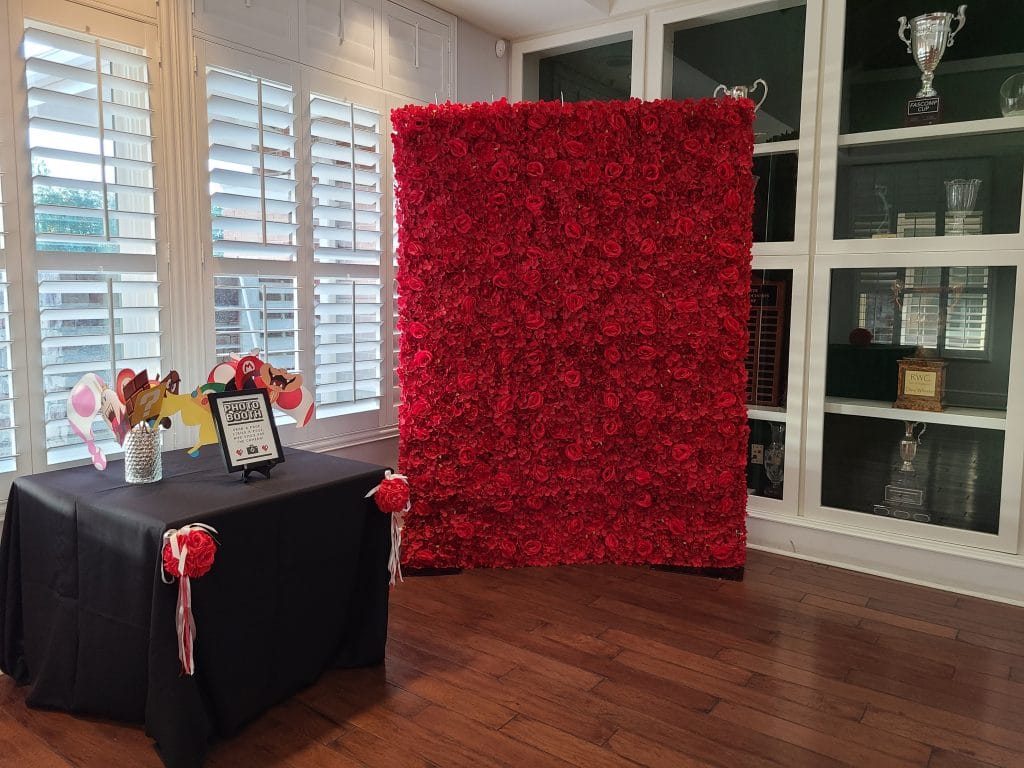 red flower wall photo booth backdrop