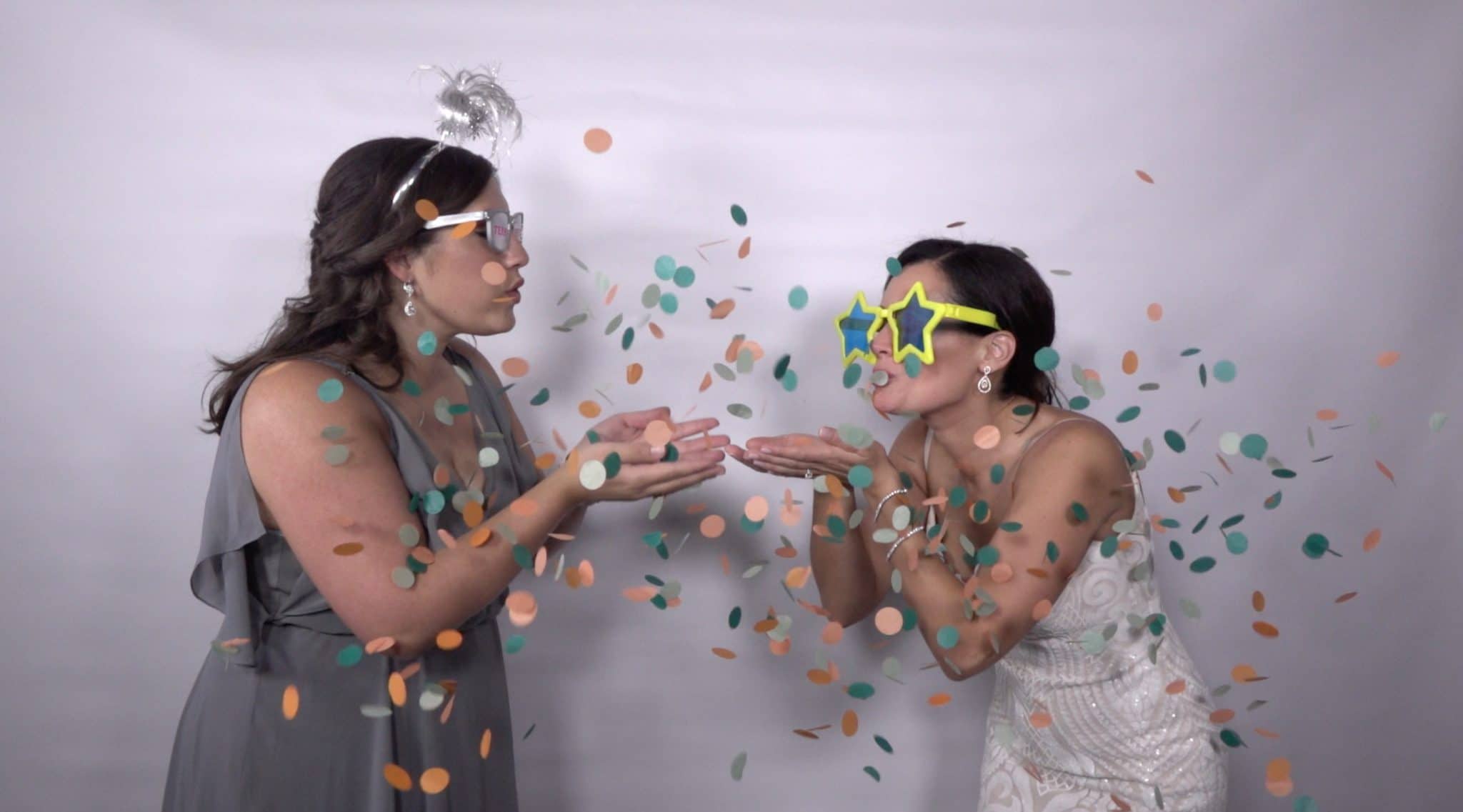 Omarvelous Productions - bride and guest blowing kisses with confetti