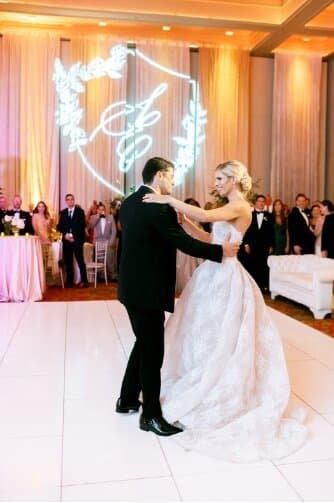 bride and groom dancing at wedding with removable sleeves on her customized wedding dress