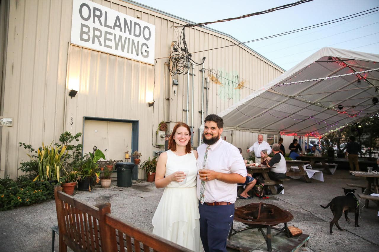 Live Happy Studio - couple standing with beer at a party at Orlando Brewing