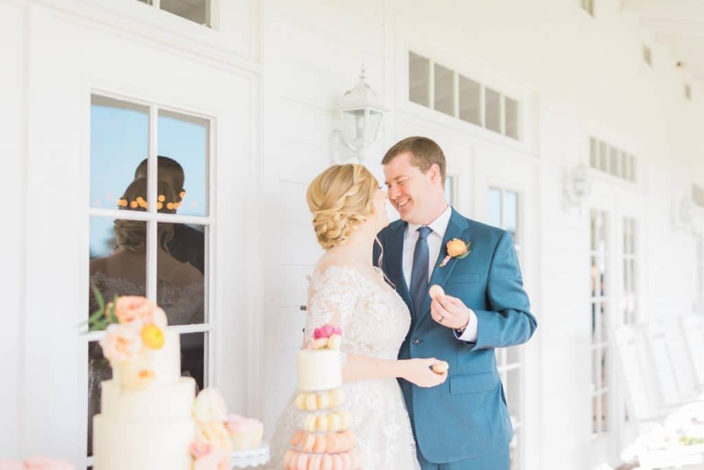 Bride and Groom on verandah with wedding cake