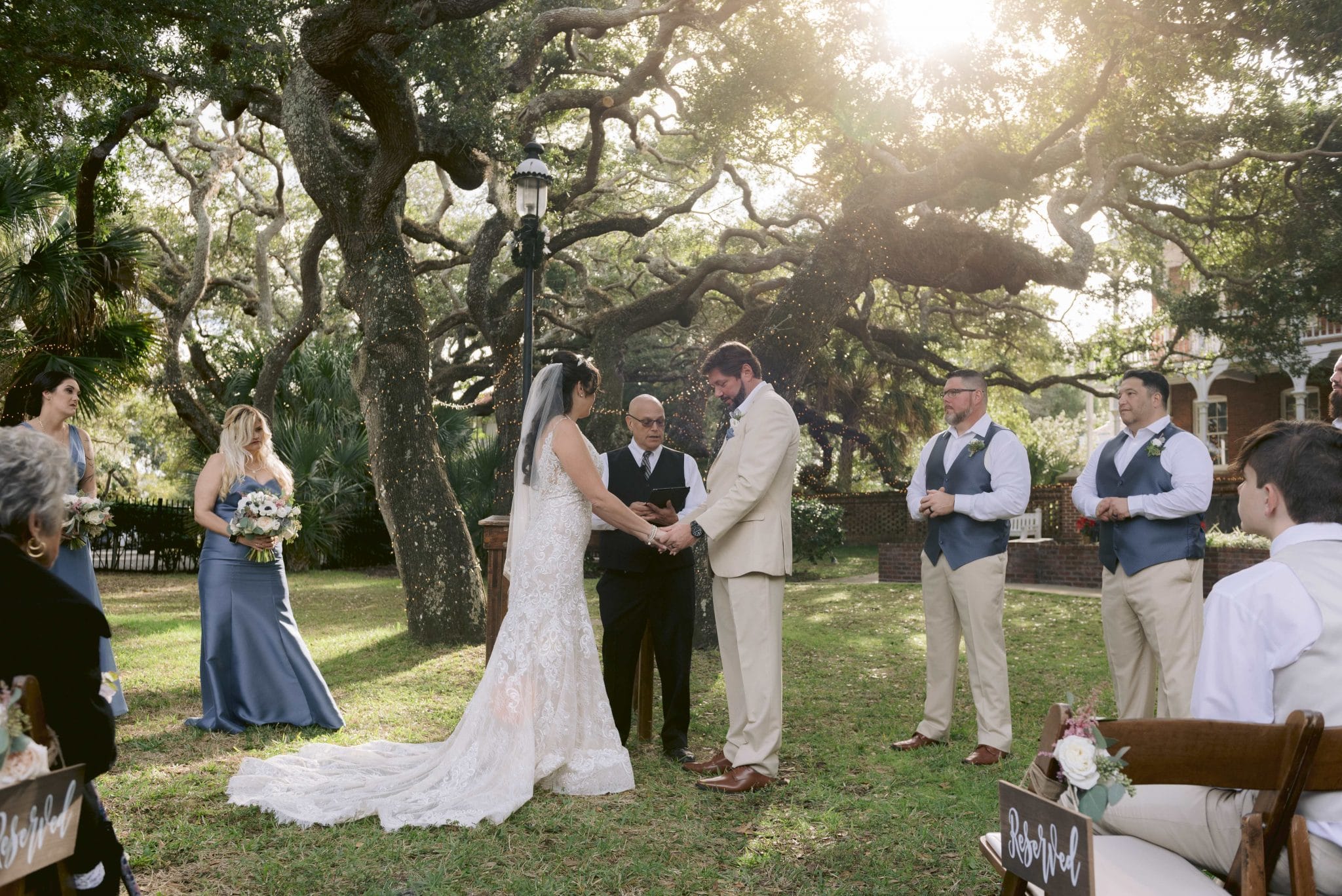 Pastor Mike officiating a wedding under the trees outside