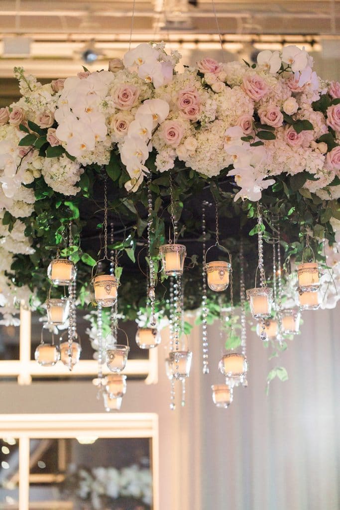 Fairbanks Florist - white and pink flowers hanging from ceiling with small candles hanging below