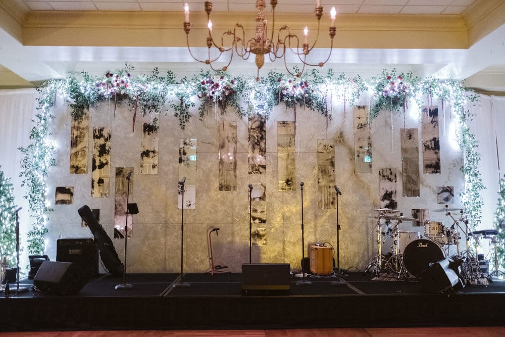 Fairbanks Florist - flower garland with lights set up behind band stage