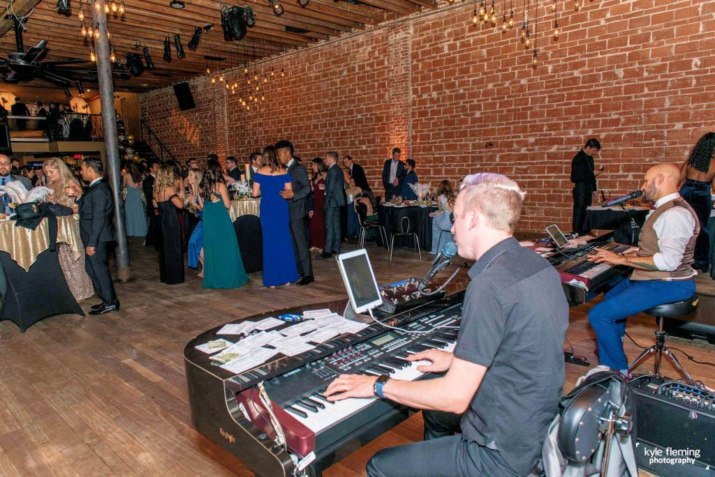 Felix & Fingers performing at a wedding party in an industrial brick building